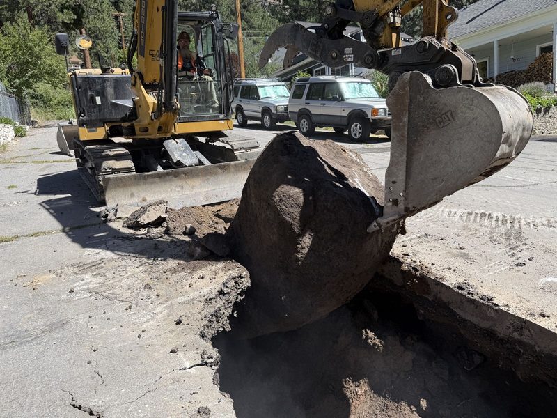 CAT 299D XHP compact track loader working a grade
