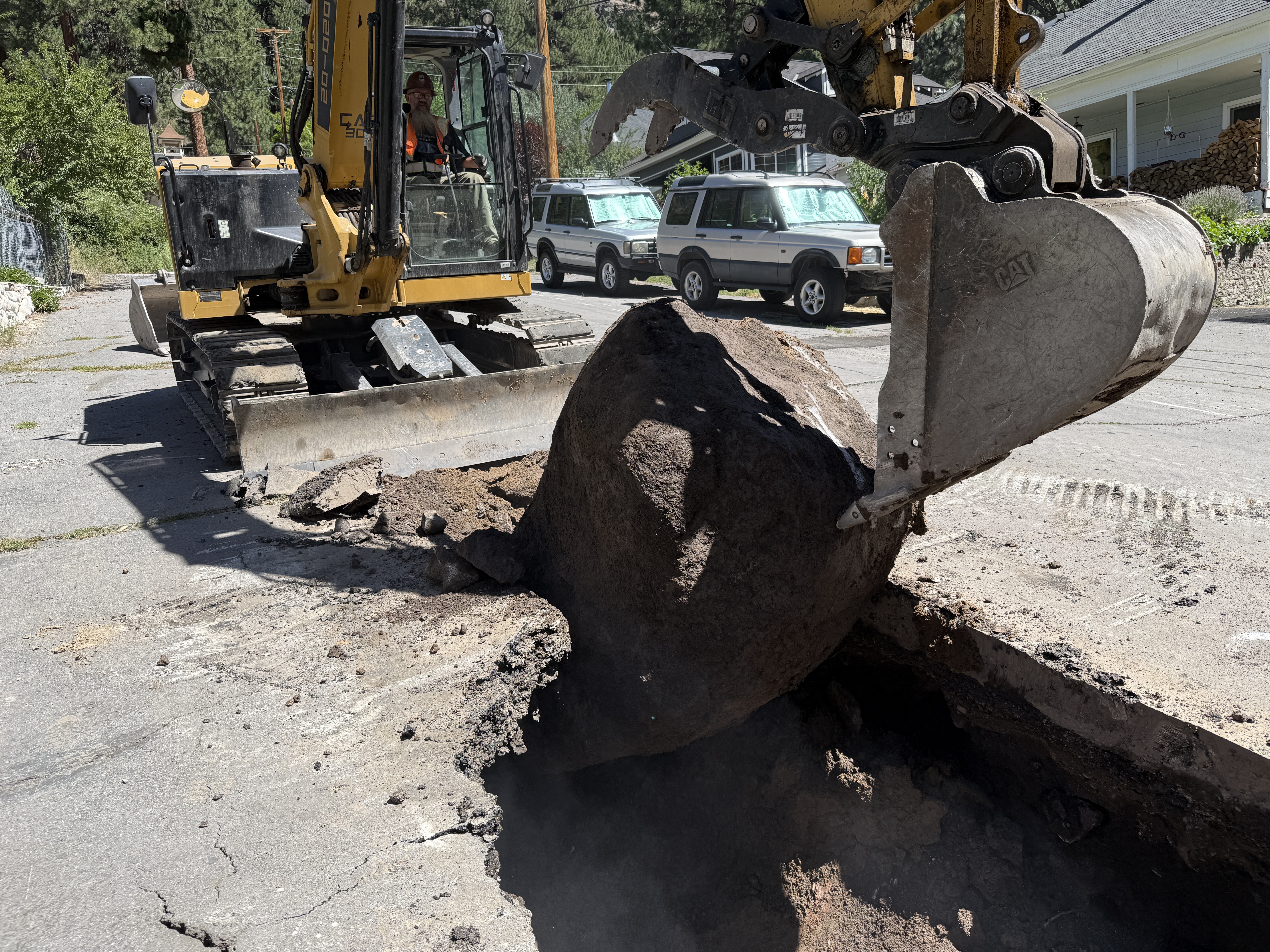 Excavator working open ground in the Sierra Nevada after spring snowmelt, Errol Kerr excavation