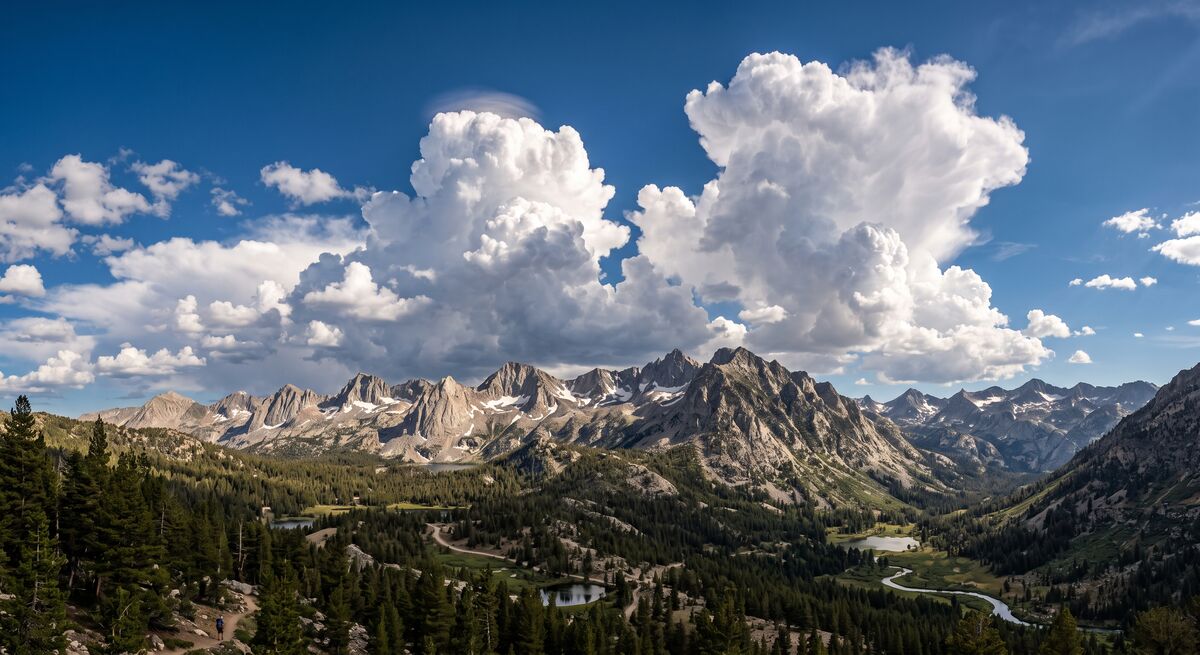 Afternoon cumulus clouds building over the Sierra Nevada mountain ridgeline in summer