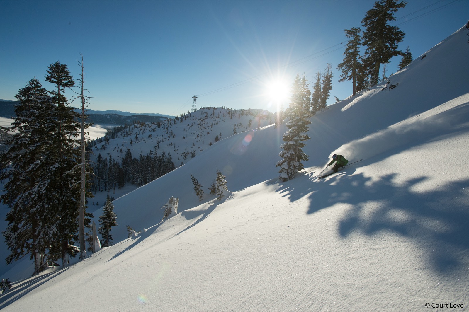 Sun-flare turn at Palisades Tahoe with KT-22 lift visible