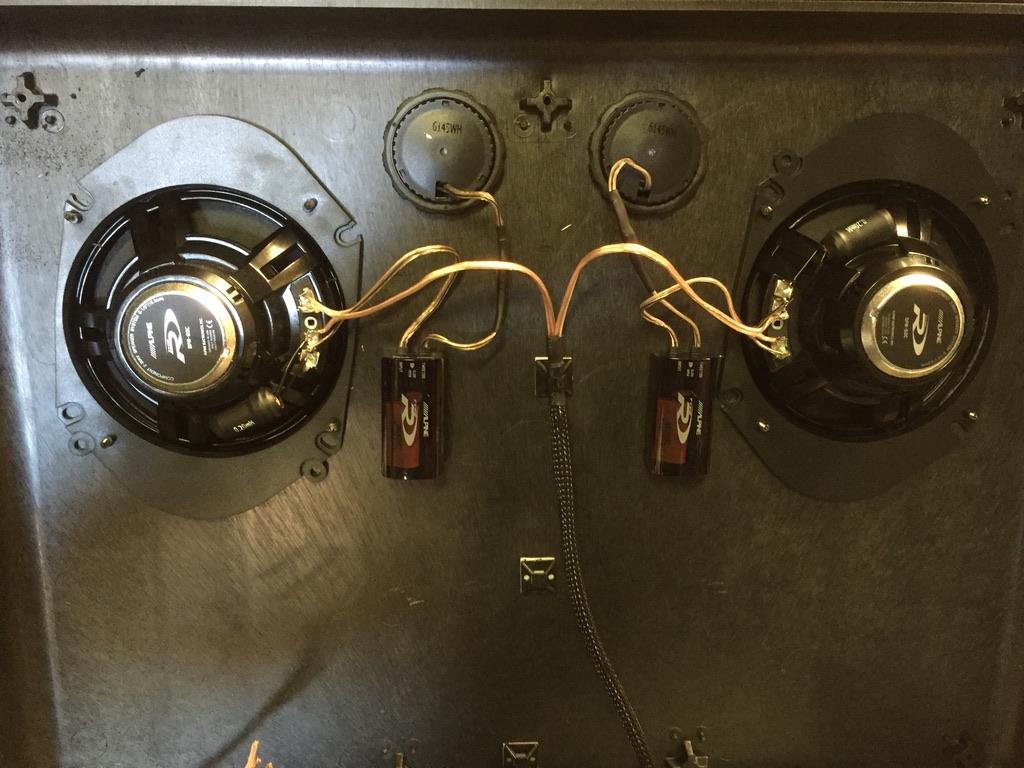 Detailed view of Alpine component speakers, tweeters, crossovers, and welded mounting brackets