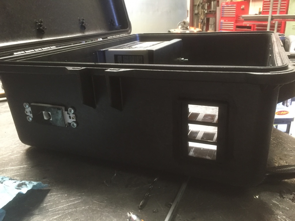Pelican case side view showing three louvered cooling vent slots and panel cutout