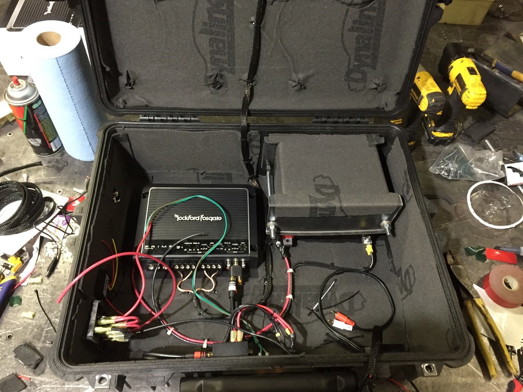 Wiring harness in progress with Rockford amp installed and battery in foam-padded cradle
