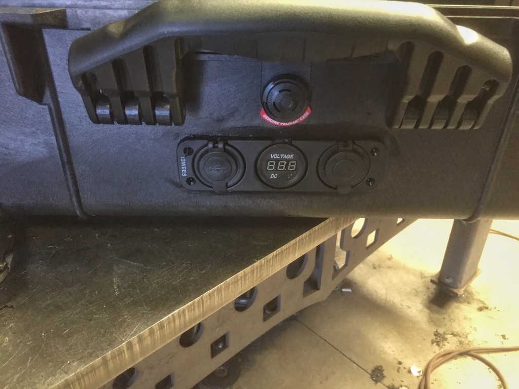 Side control panel showing power lock, voltmeter, USB port, and locking handle