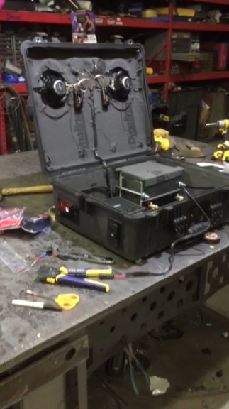 Open Pelican boom box on welding bench during late testing showing all internals