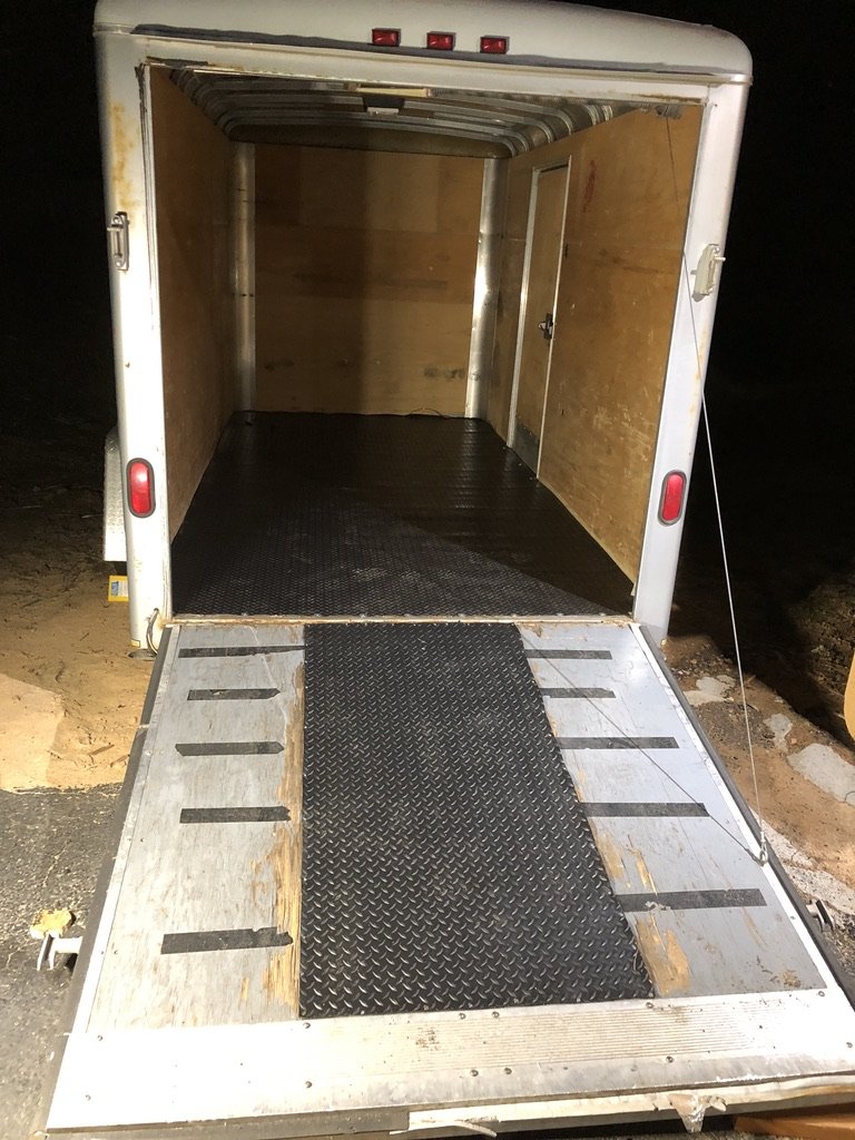 Trailer empty with ramp open at night, looking through to the front bulkhead