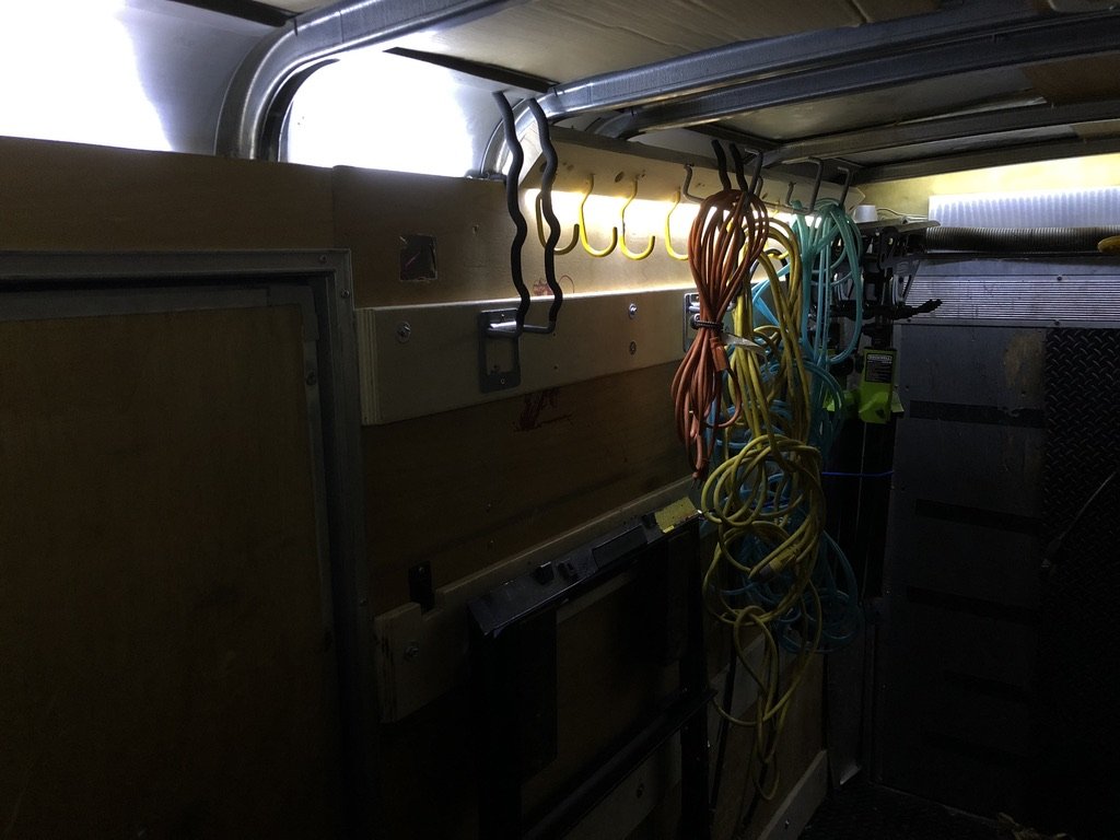 Cable management system with extension cords hung on bent rebar hooks
