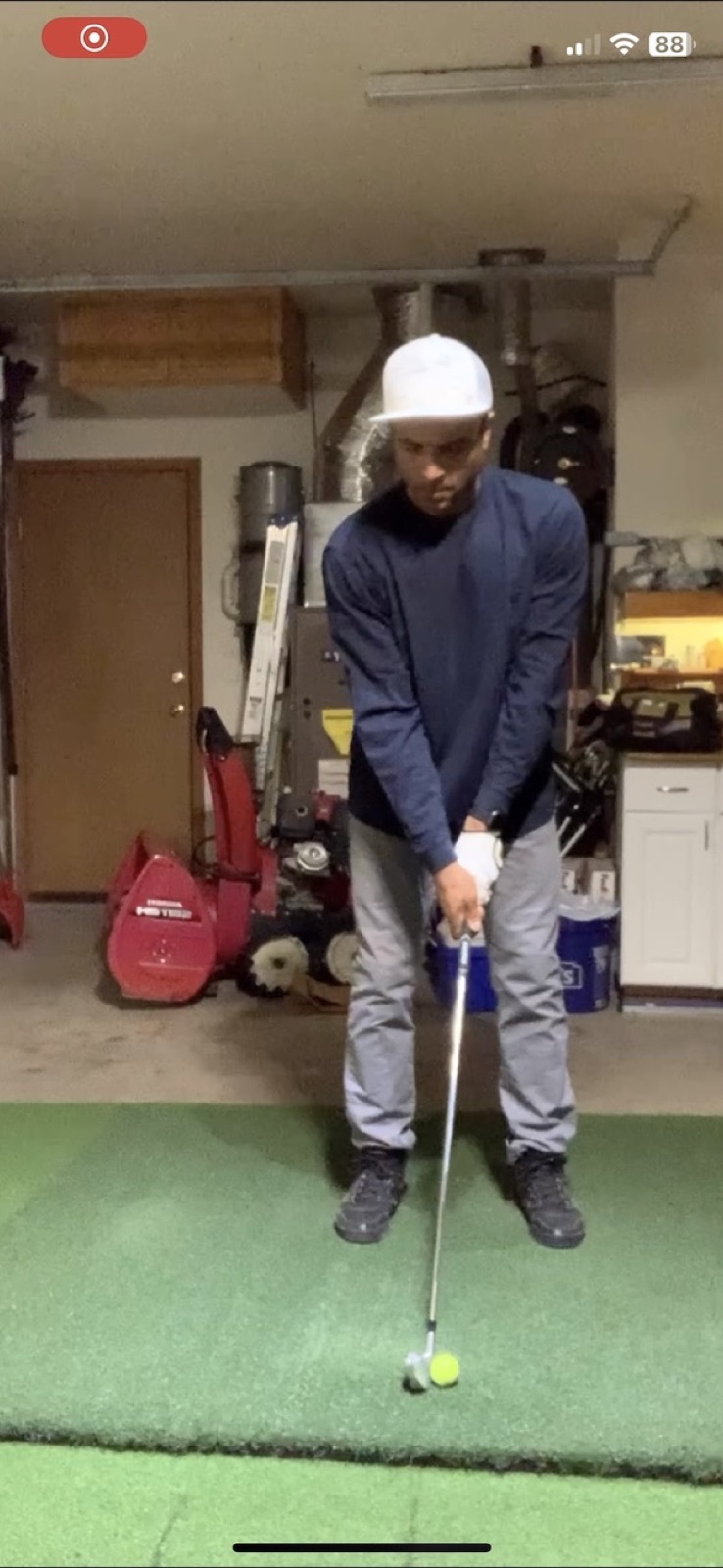 V2 putter practice with garage in background