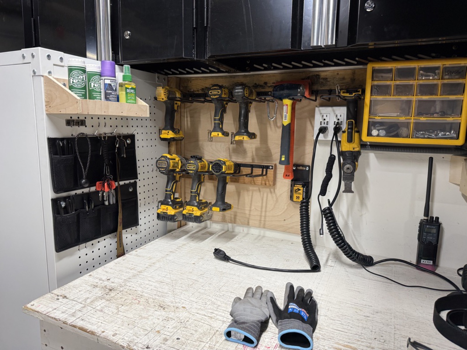 Close-up of the pegboard with DeWalt cordless drill rack and small-parts organizer