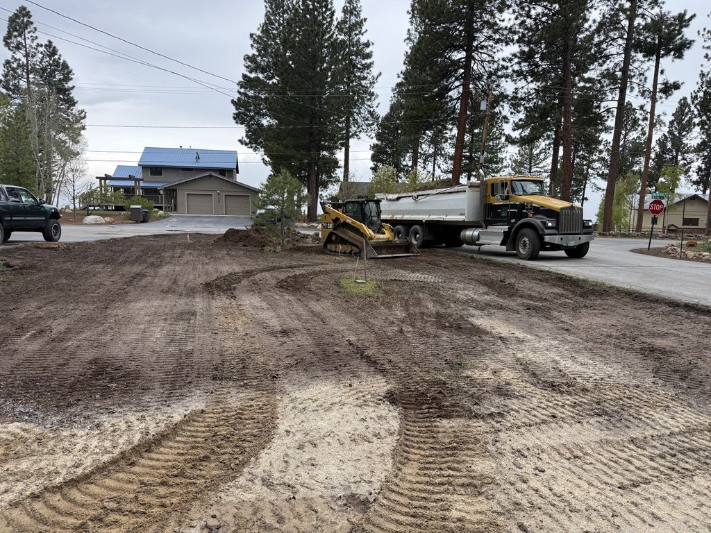 Excavation in progress, dirt being moved into the dump trailer