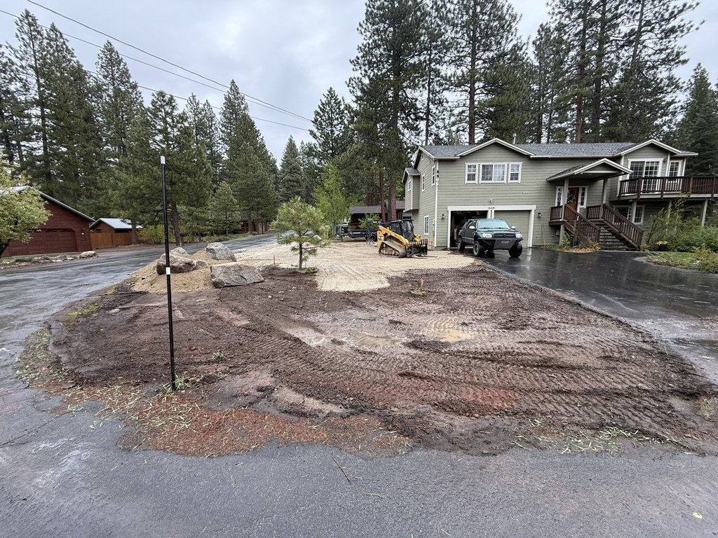 Mid-excavation, subgrade exposed and getting compacted