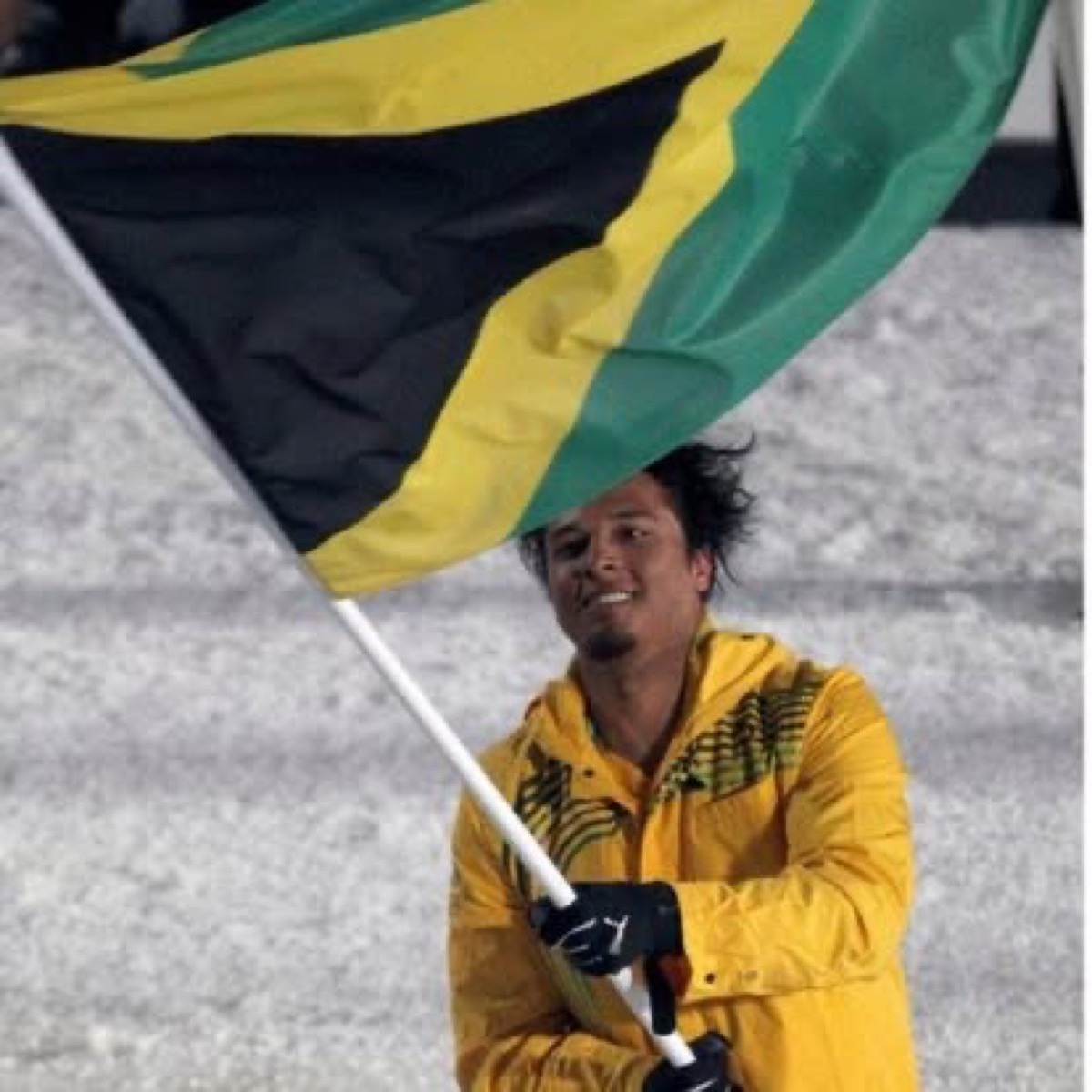 Close-up of Errol Kerr carrying the Jamaican flag at the 2010 Vancouver Olympics Opening Ceremony
