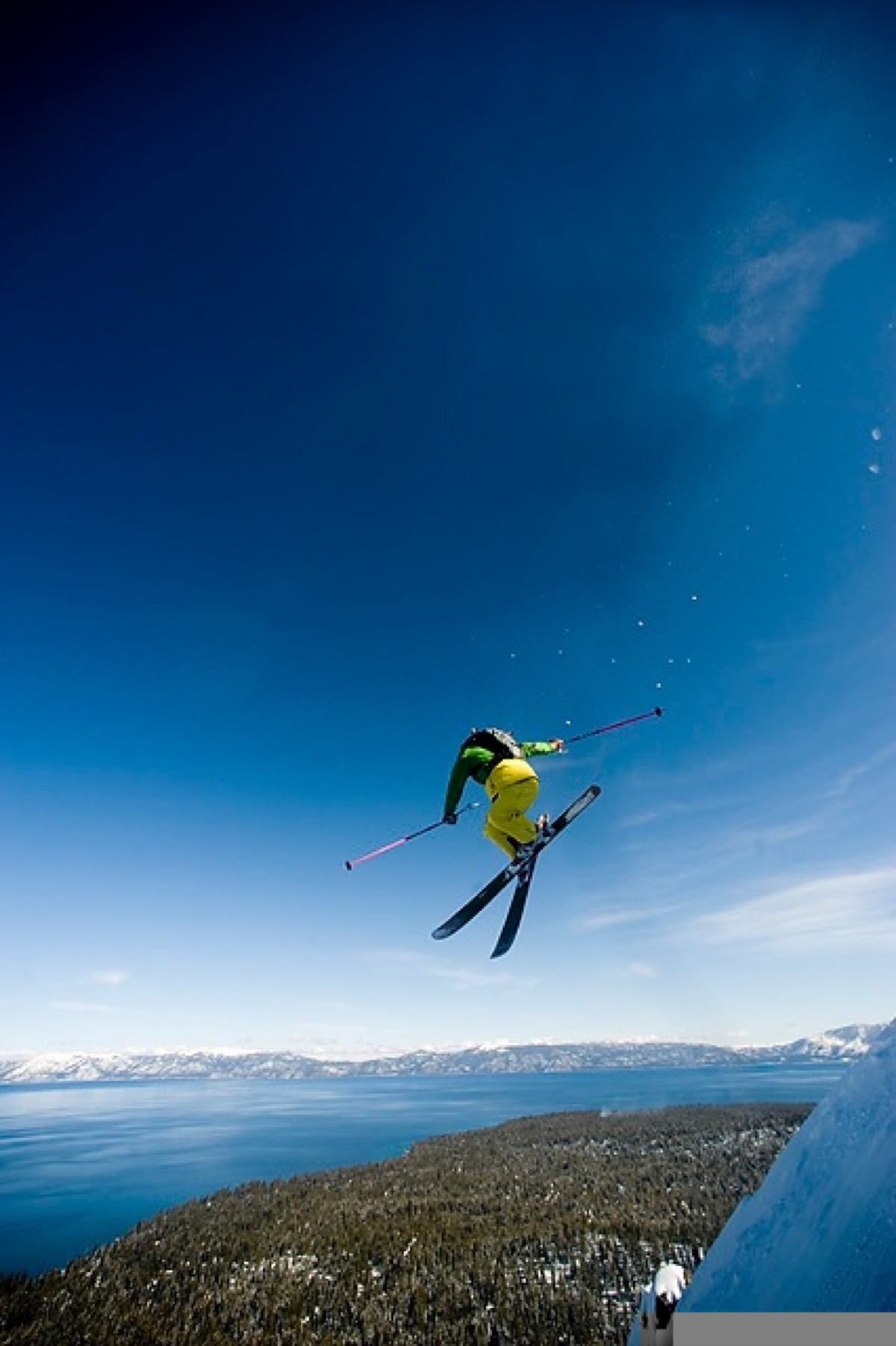 Errol mid-air during a ski jump above Lake Tahoe, fully committed