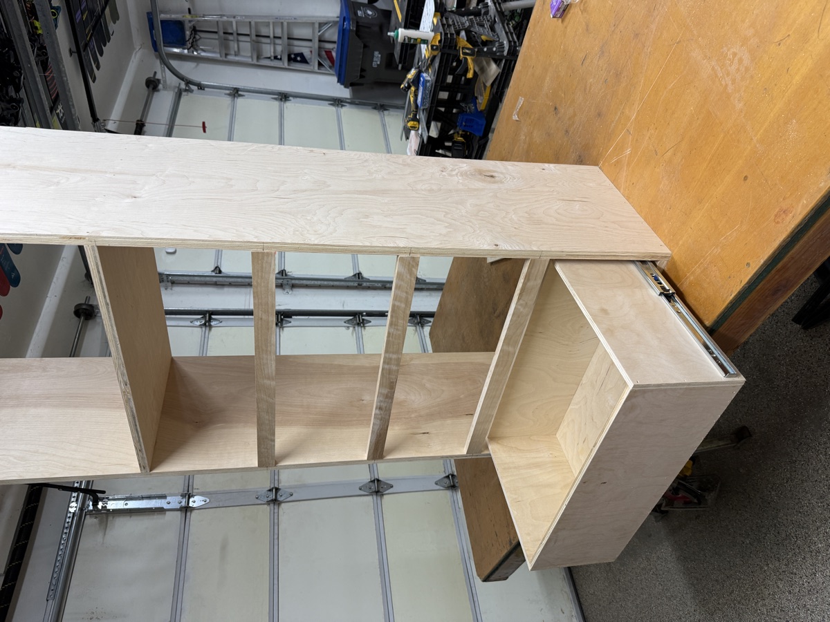 Shelving tower with a drawer extended on full-extension slides