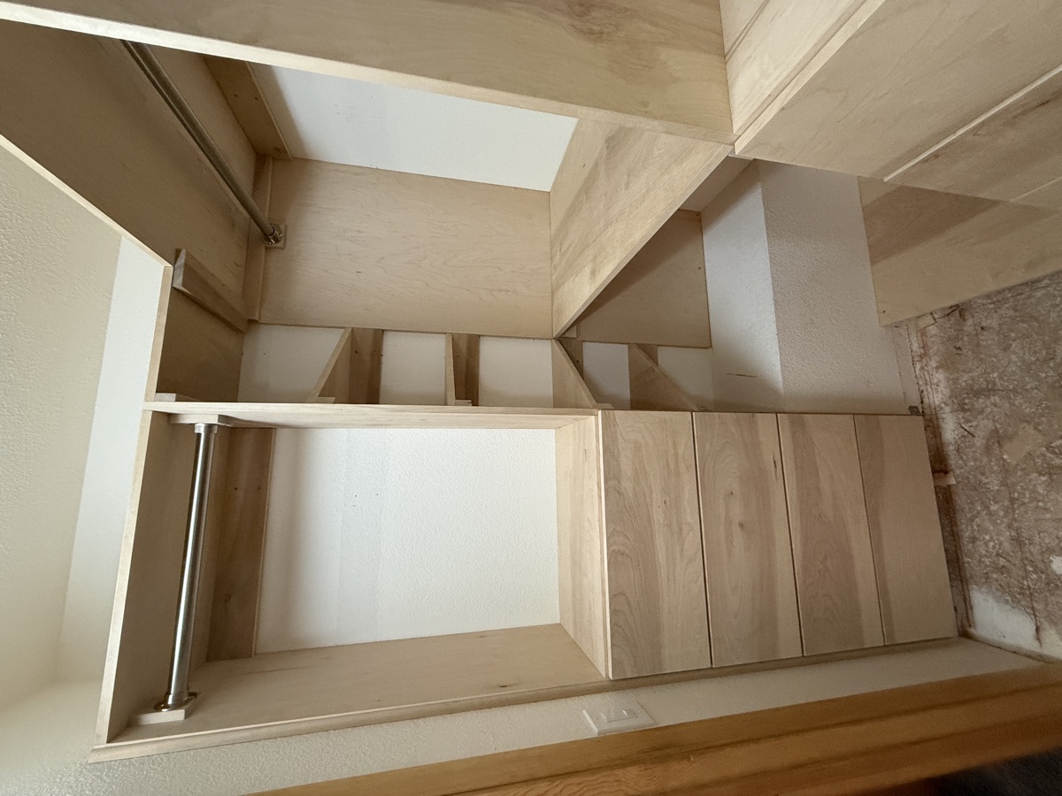 Walk-in closet from entry angle showing full built-in system