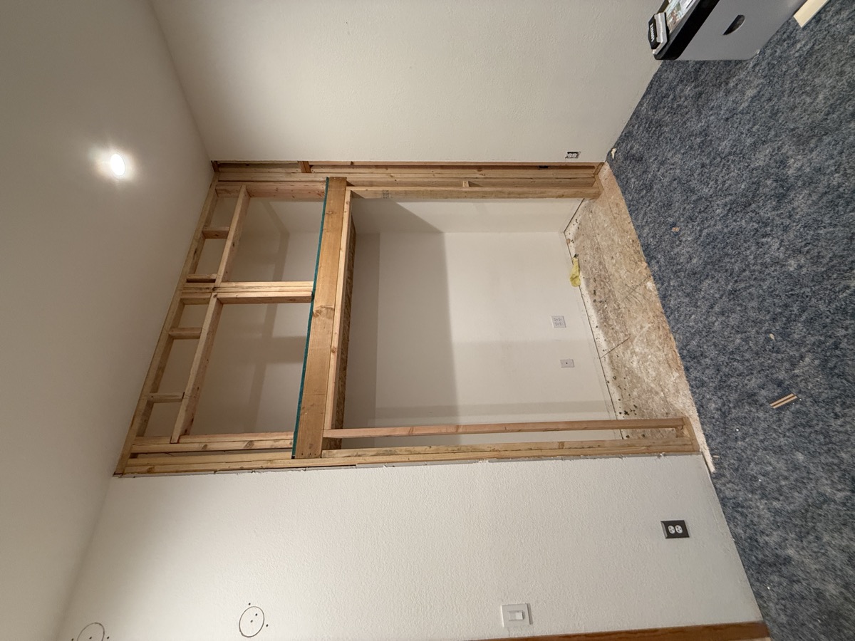 Closet opening framed with header and studs in the eave space