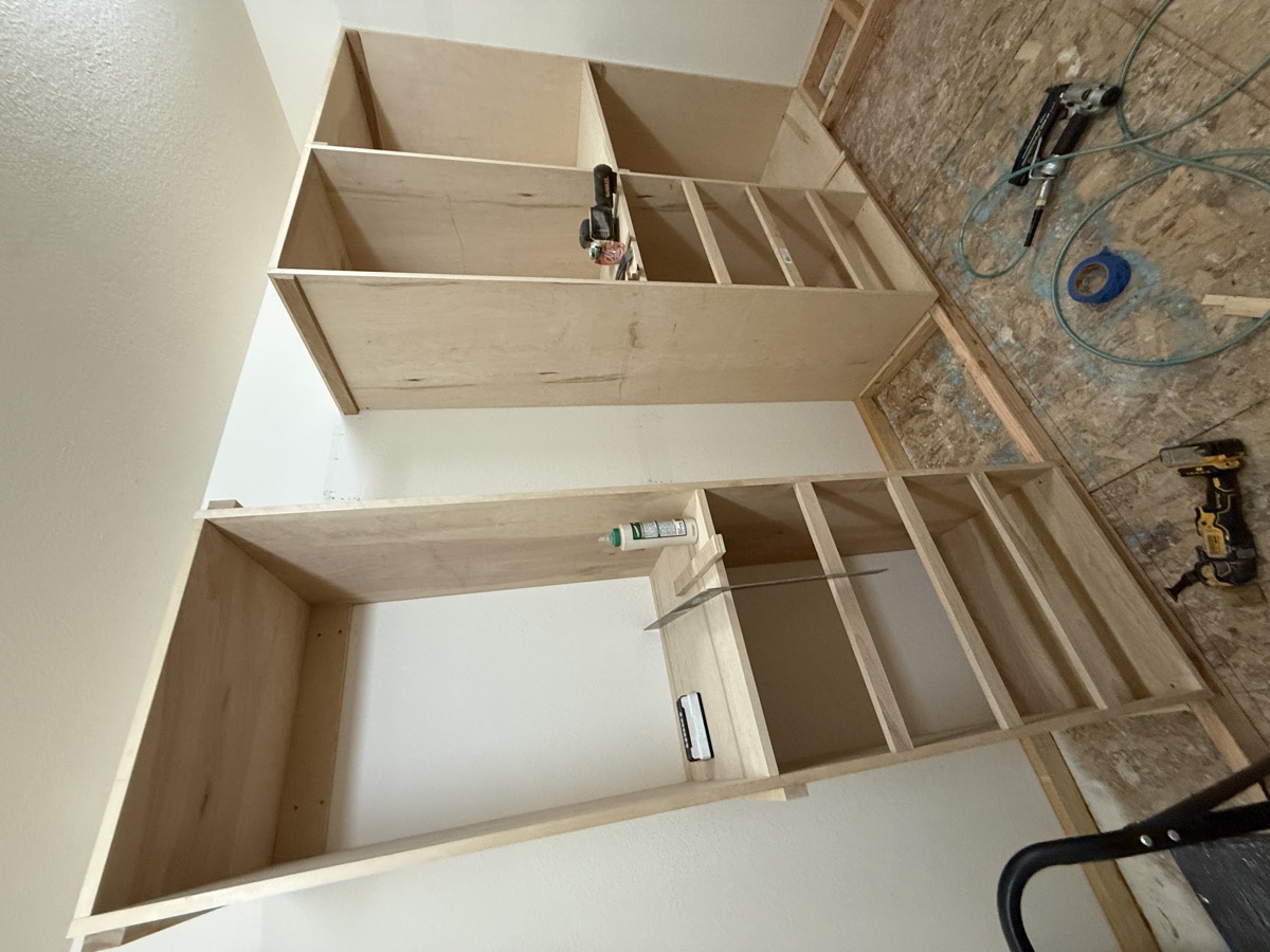 Built-in shelving towers installed in the walk-in closet