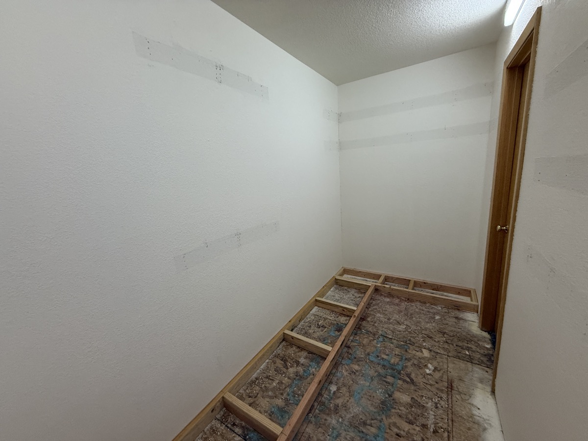 Walk-in closet interior fully framed with knee walls and header