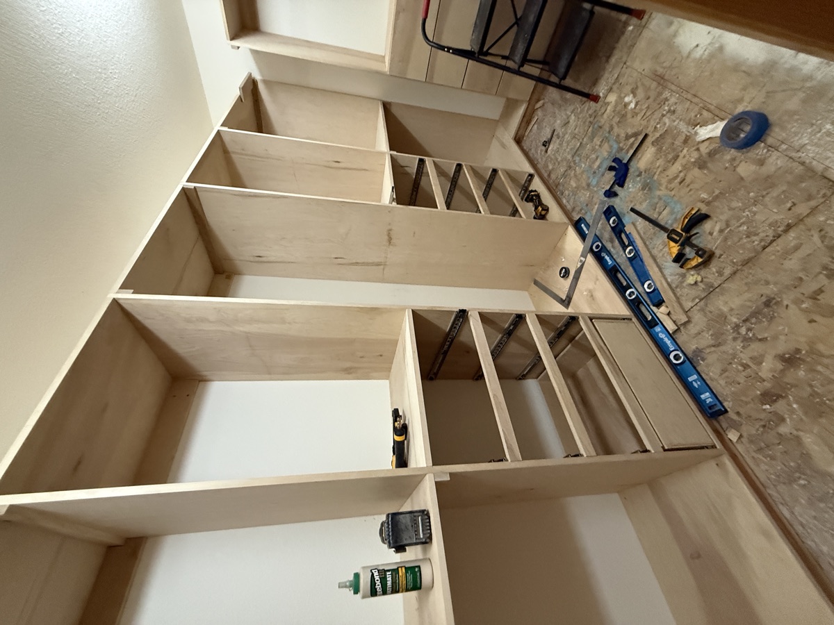 Shelving towers being set into the walk-in closet space