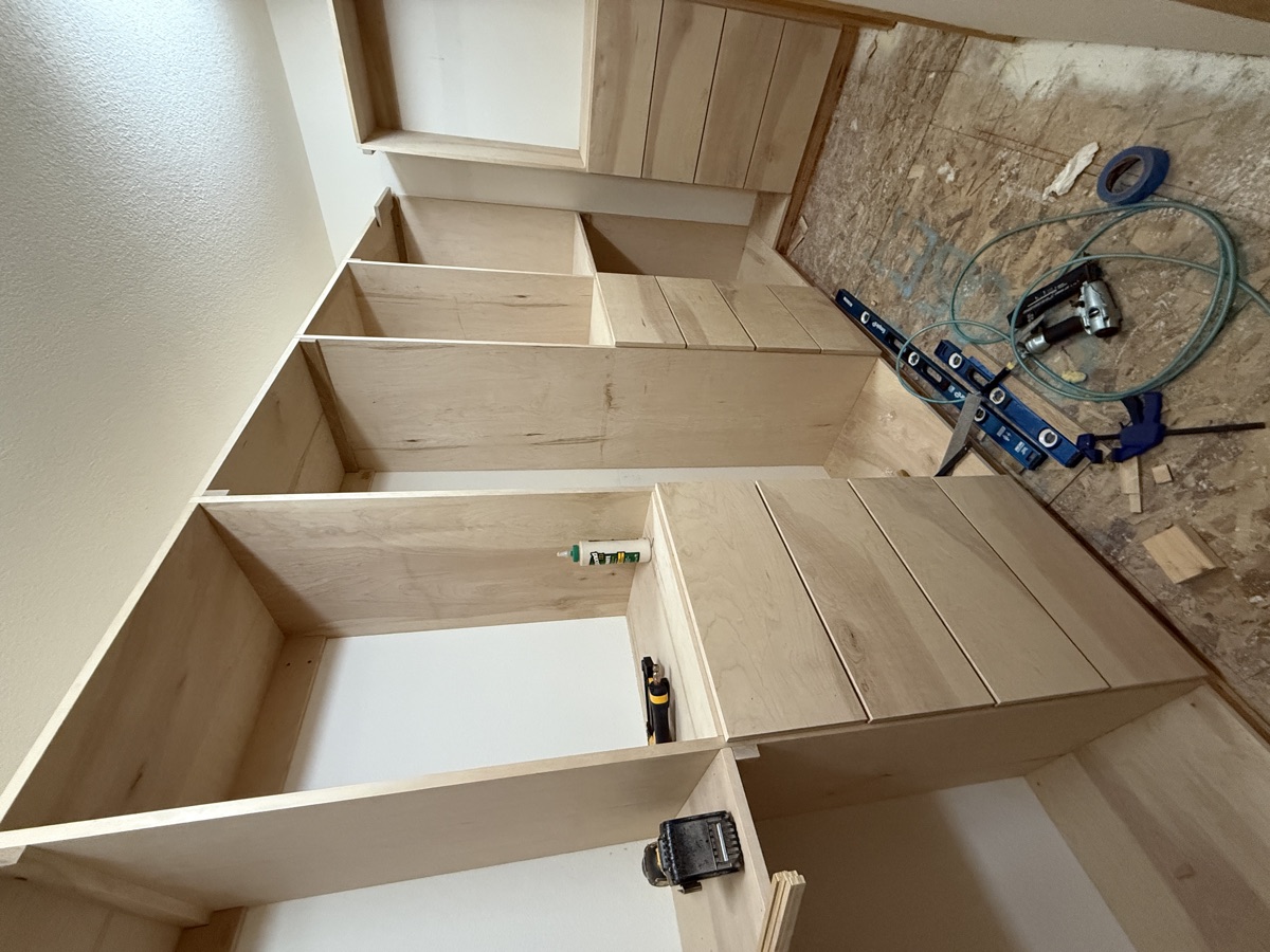 Built-in shelving towers anchored to wall studs