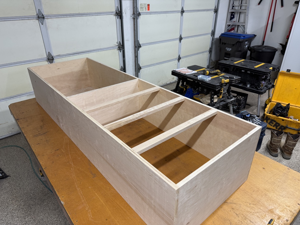Plywood shelving tower with dividers on the workbench