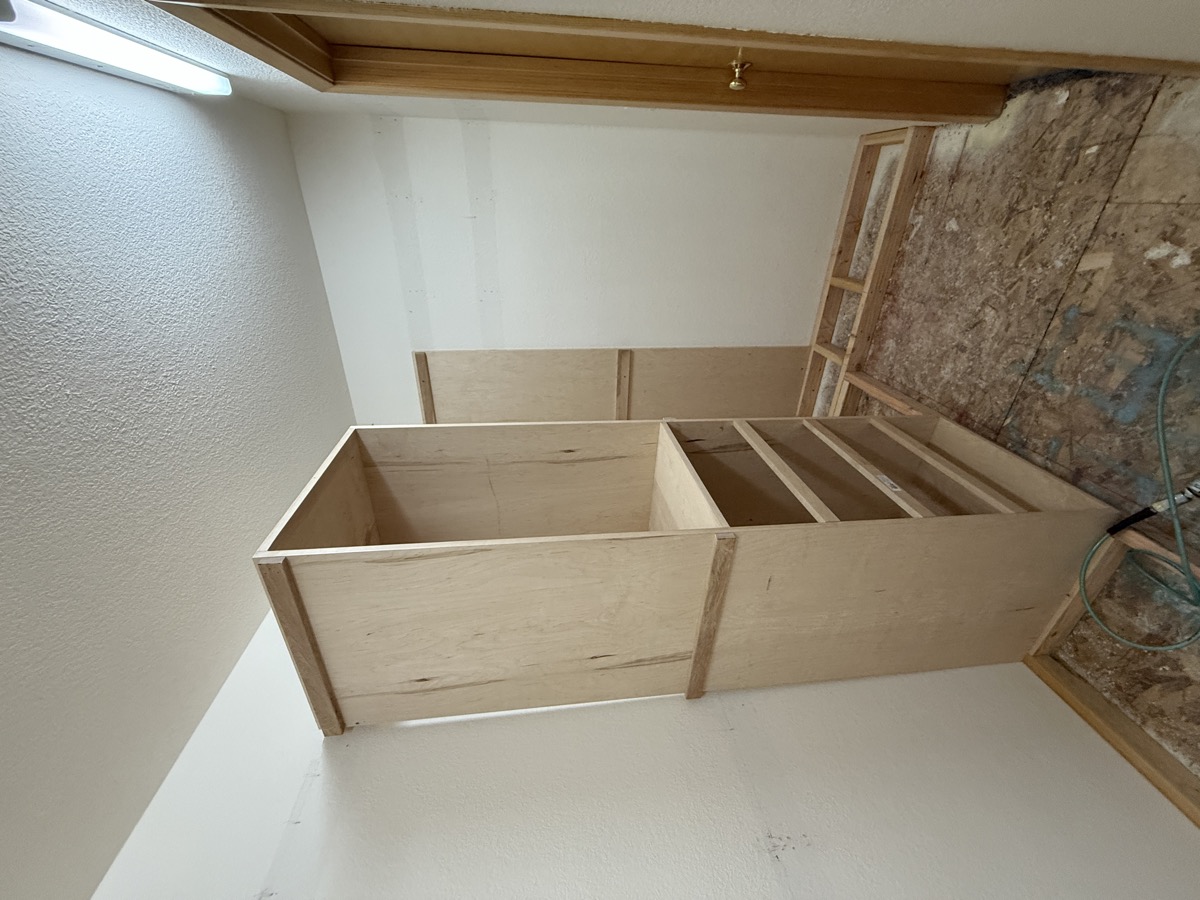 Looking down into closet subfloor framing before install