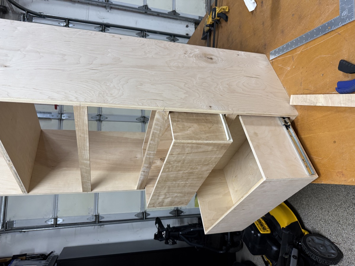 Close-up of shelving tower top showing drawer slide hardware mounted
