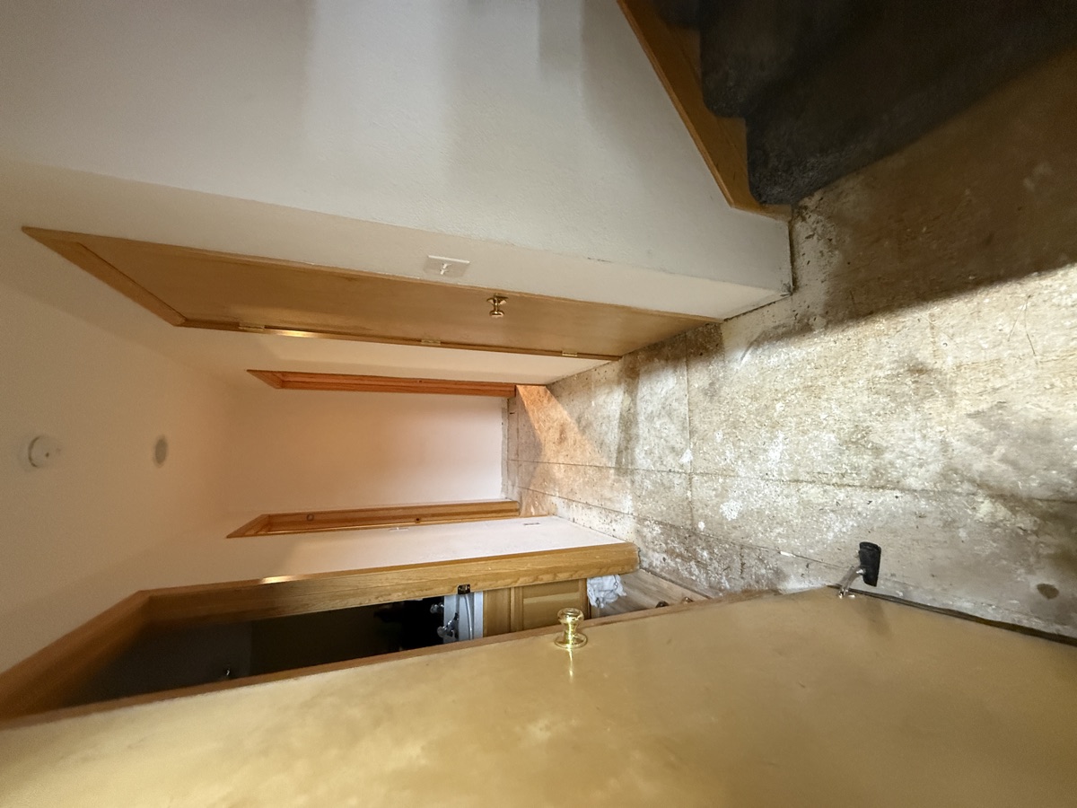 Subfloor showing concrete patches, OSB transitions, and plumbing penetrations