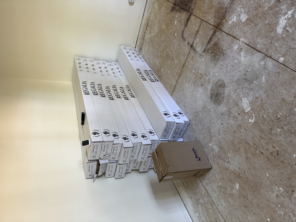 Regalia hardwood flooring boxes stacked on subfloor with Bostik adhesive product