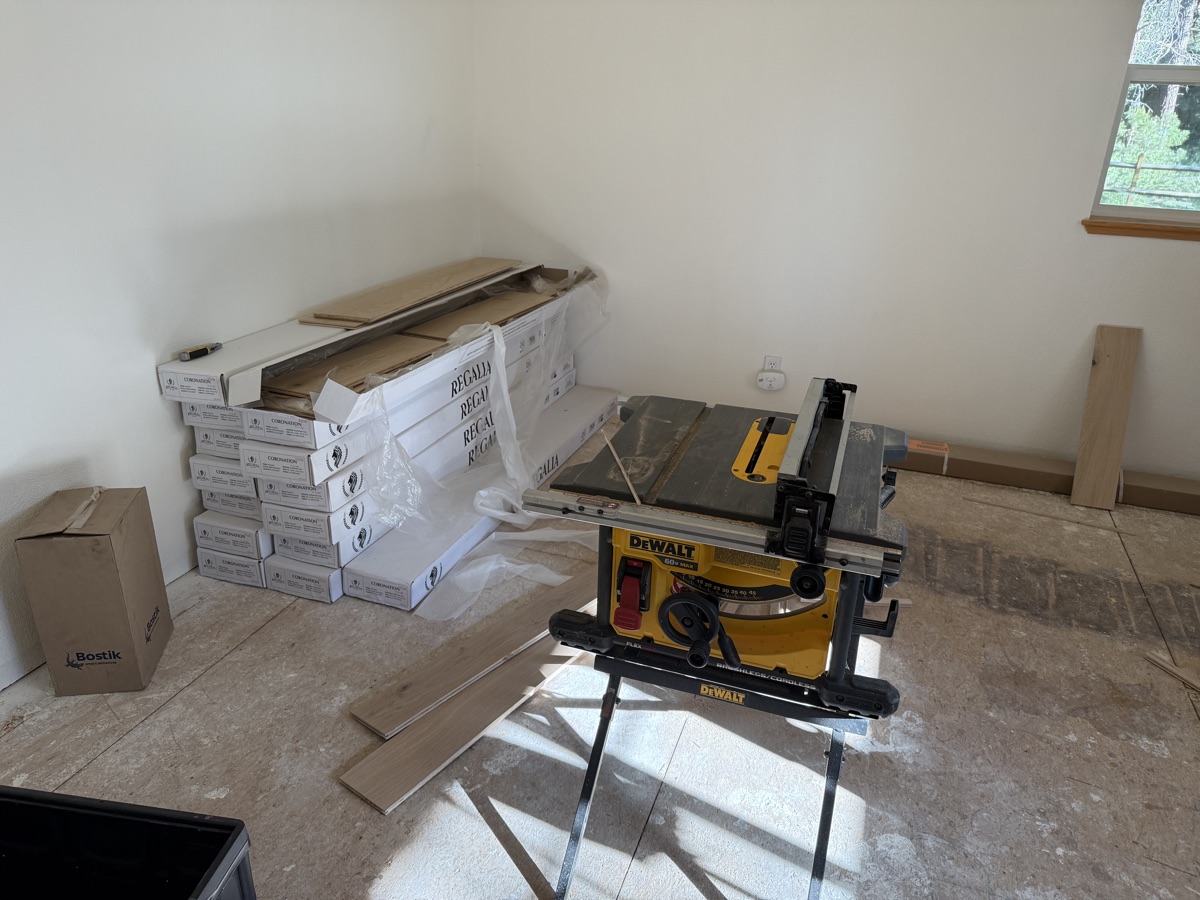 DeWalt table saw cut station set up in adjacent room with Regalia flooring boxes