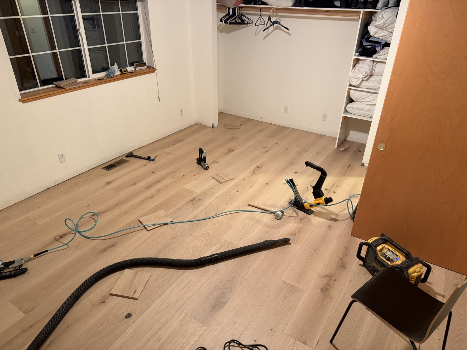 Completed bedroom hardwood floor with walk-in closet integration