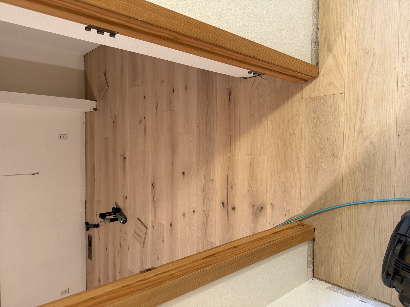 Hardwood floor hallway transition between rooms showing seamless plank continuity