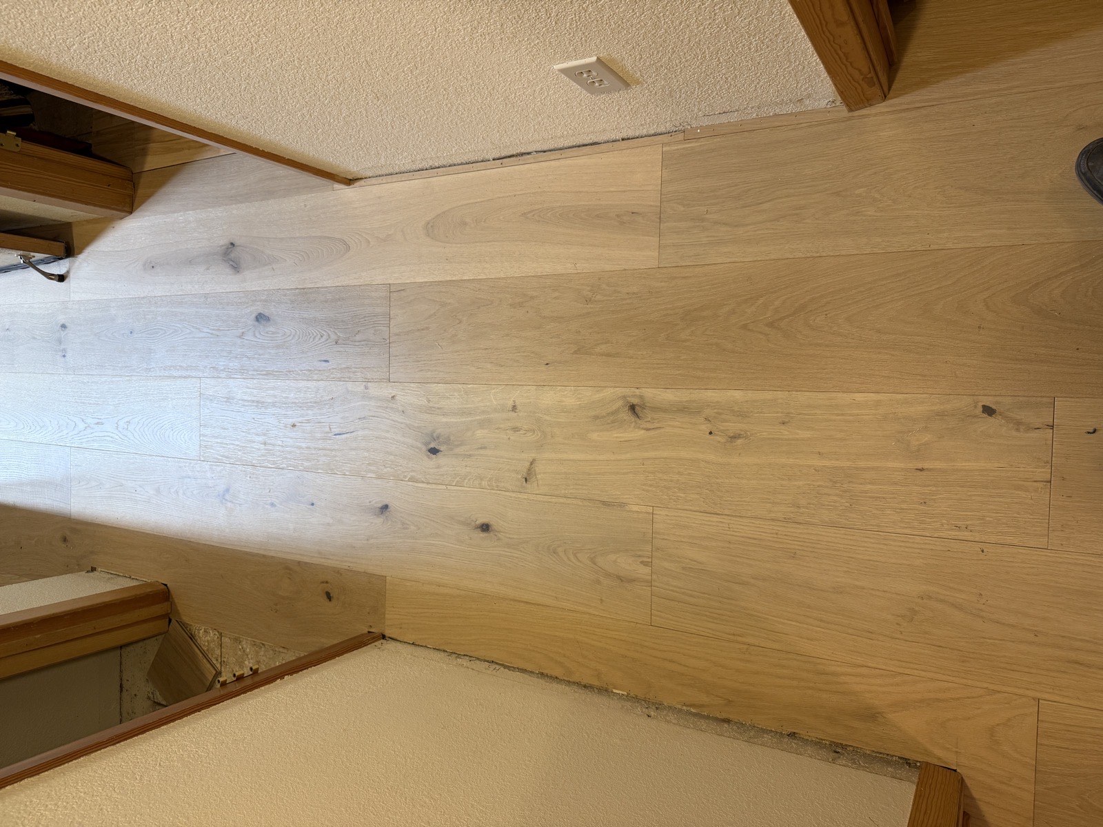 Wide-plank white oak floor showing stagger pattern and hallway perspective